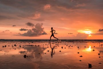 Running on a beach at sunset